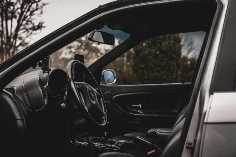 the interior of a car with a steering wheel and dashboard